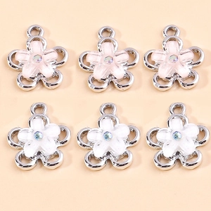 Detail of flower charms with pink and white petals and sparkling center rhinestones