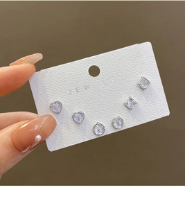 Detailed view of 925 silver stud earring set with zircon heart and geometric shapes