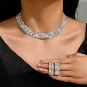 Close-up of bridal rhinestone necklace and rings set with iridescent AB crystals