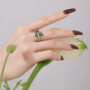 Elegant silver open ring with emerald green leaves and cubic zirconia stones