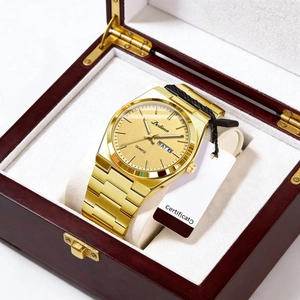 Close-up of gold steel watch with dual calendar in a luxury red wooden gift box
