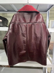 Close-up of wine red faux leather jacket with plush lamb wool collar for winter warmth