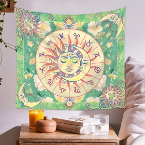 Detail of bohemian sun and moon tapestry with zodiac motifs on a cozy bedroom wall