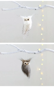 Detail of plush owl Christmas ornaments in white and brown with realistic feather texture