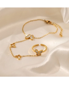 Close-up of butterfly jewelry set with white shell inlay and 18K gold plated steel