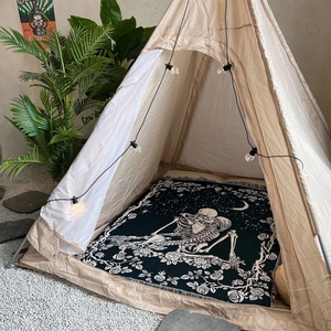 Bohemian woven camping blanket featuring gothic skeleton and rose print inside a tent