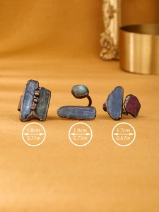 Detail view of vintage copper rings with raw stones and size measurements in cm and in