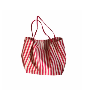 Classic large canvas tote bag with red and white stripes and sturdy red handles