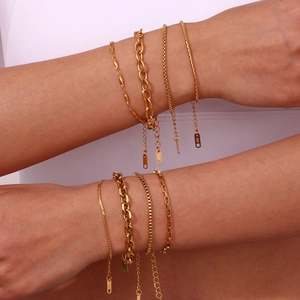 18K gold plated stainless steel bracelet set with Cuban and snake chain styles on a model