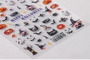 Macro shot of Halloween nail art stickers with watercolor ghosts, pumpkins and bats