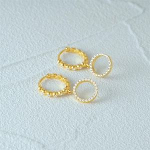 Close-up of gold S925 silver double hoop earrings with sparkling zircon inlay