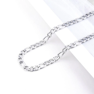 Macro shot of silver titanium steel Figaro chain necklace links on white background