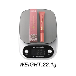 Lush glow cushion lip gloss in deep pink with matching box on digital scale weighing 22.1g