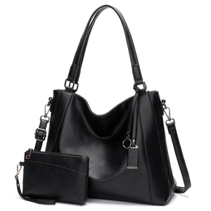 Detail view of the black textured leather tote bag and matching inner pouch set