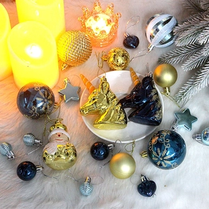 Detail of colorful unicorn, snowman, and star ornaments on white fur with pine branches