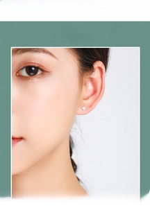 Close-up of minimalist S925 sterling silver star stud earring worn on model's ear