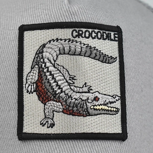 Grey cotton baseball cap featuring detailed crocodile animal embroidery patch on front