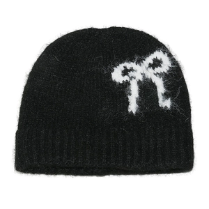 Women's black knit beanie with a white bow pattern in soft plush mohair wool