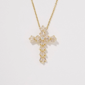 Minimalist gold cross pendant necklace with sparkling white zircons on a fine wave chain