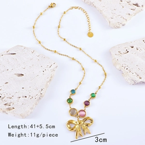 Detail view of colorful beads and bow pendant on golden necklace with size markers