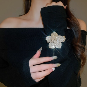 Close-up of sparkling adjustable flower bracelet with crystals on a black sleeve