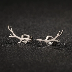 Macro view of polished silver stainless steel reindeer antler stud earrings with butterfly backs