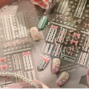 3D embossed nail stickers featuring white knit texture and pink bow snowflake designs