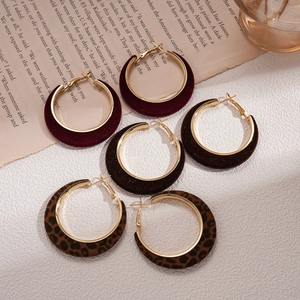 Three pairs of vintage velvet hoop earrings in burgundy, dark brown and leopard print