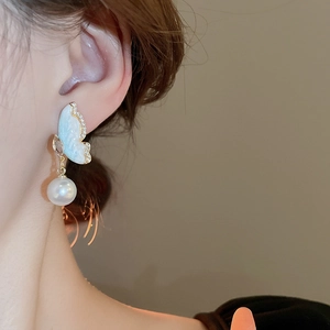 Elegant butterfly earrings with blue wings, sparkling zircons and white pearls