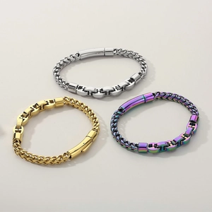 Detail view of gold, silver, and iridescent dragon bone chain bracelets with pig nose clasp