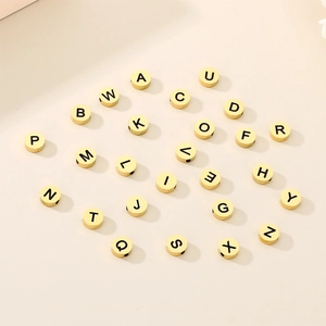Set of 26 gold stainless steel round alphabet beads from A to Z with black engraving