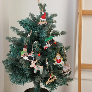 Handcrafted wooden Christmas tree ornaments featuring Santa and reindeer on a tree