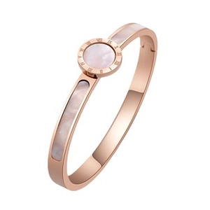 Detail of rose gold cable bracelet with white shell inlay and Roman numeral engravings