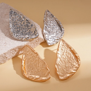 Minimalist irregular metallic leaf earrings in textured silver and gold finishes