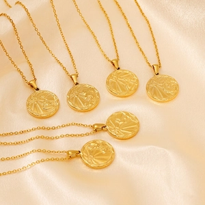 Golden zodiac coin pendant necklace set with vintage embossed astrology charms on silk