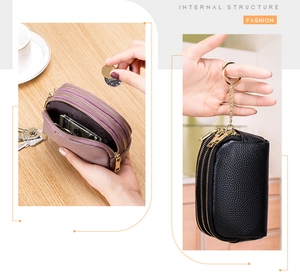 Detail view of leather mini wallet with three zip pockets and gold metal keyring