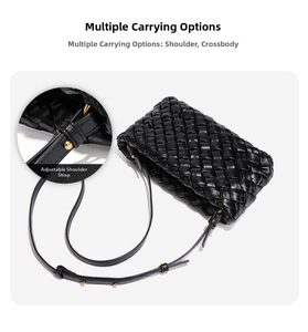 Detail of black woven leather crossbody bag with adjustable strap and golden metal buckle
