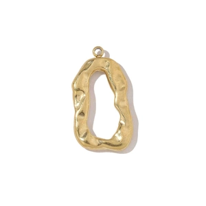 Detailed view of irregular oval gold charm pendant with hammered texture for DIY jewelry