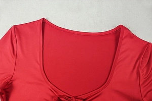 Detailed view of the red long-sleeve dress neckline with precise stitching and U-neck design