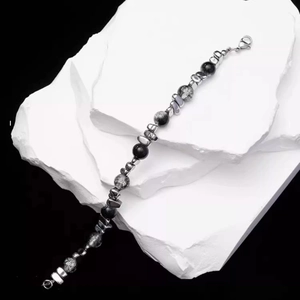 Minimalist beaded bracelet with black and grey stones and titanium steel clasp on white stones