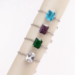 Detail of adjustable chain rings with square emerald cut zircons in four vibrant colors