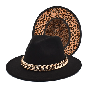 Detail of fedora hat showing classic black felt and leopard print brim with gold chain