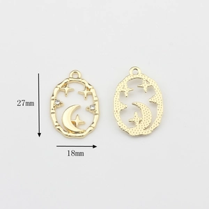 Detailed view of gold alloy star and moon charms with rhinestones and 27x18mm measurements