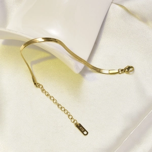 Detail of 18K gold-plated flat snake chain with lobster clasp and adjustable link