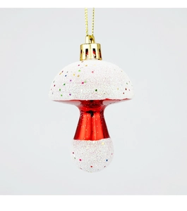 Close-up of a festive red and white mushroom Christmas ornament with gold hanging string