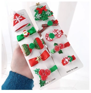 Close-up of 10-piece Christmas hair clips set featuring Santa, trees and red bows