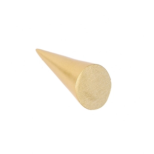 Detail view of a golden conical jewelry display stand with a brushed metal texture