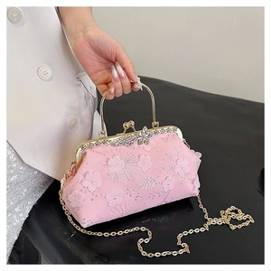 Detailed view of pink jacquard evening bag with floral sequins and butterfly clasp