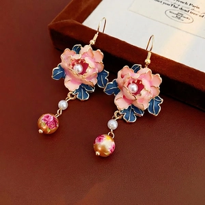 Vintage enamel peony flower earrings with pearls and gold beads on leather background