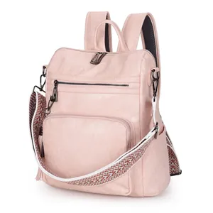 Pink faux leather backpack with geometric pattern woven strap and tassel details